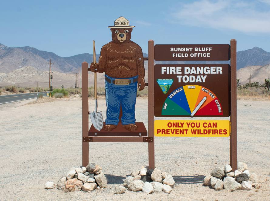 Smokey Bear fire danger sign in desert