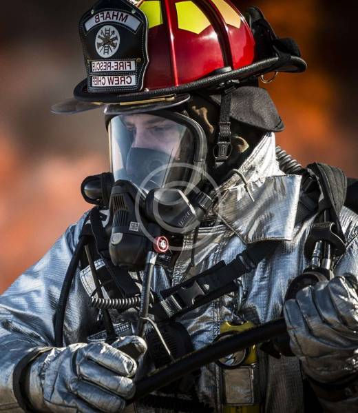 Firefighter in silver suit with breathing mask